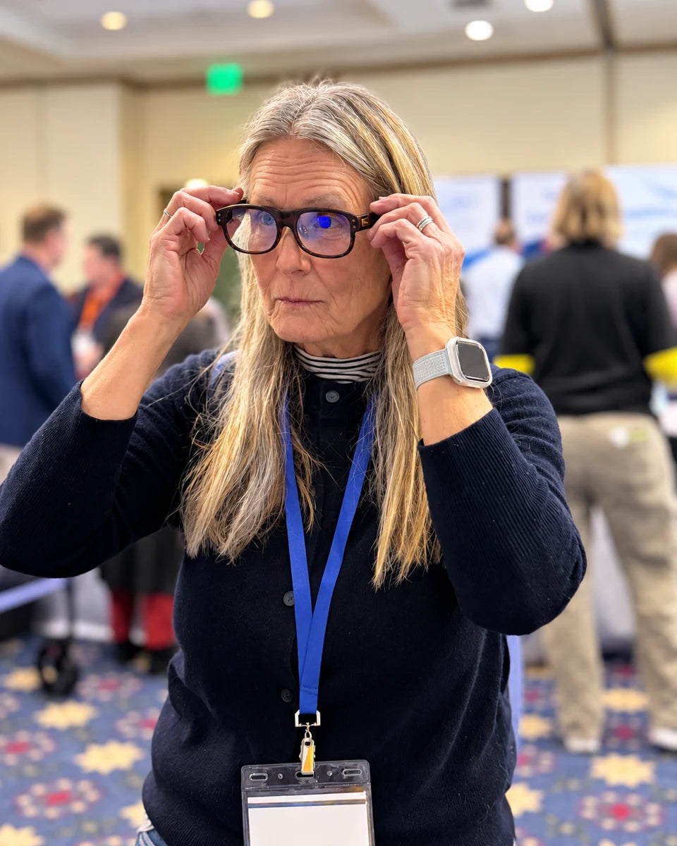 Attendee adjusting LEION Hearing caption glasses during ALDAcon 2026