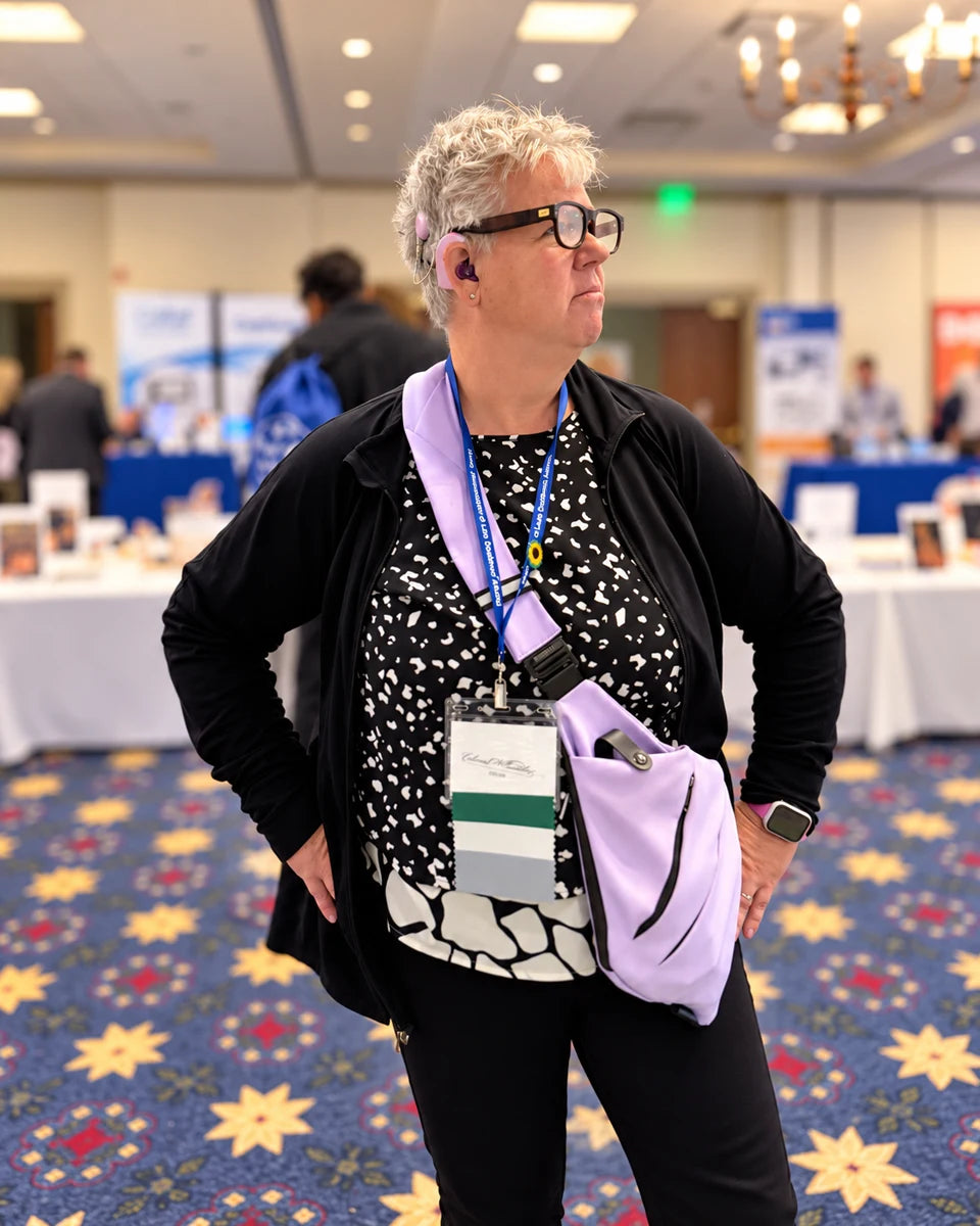 Attendee wearing LEION Hearing glasses in the ALDAcon exhibit hall